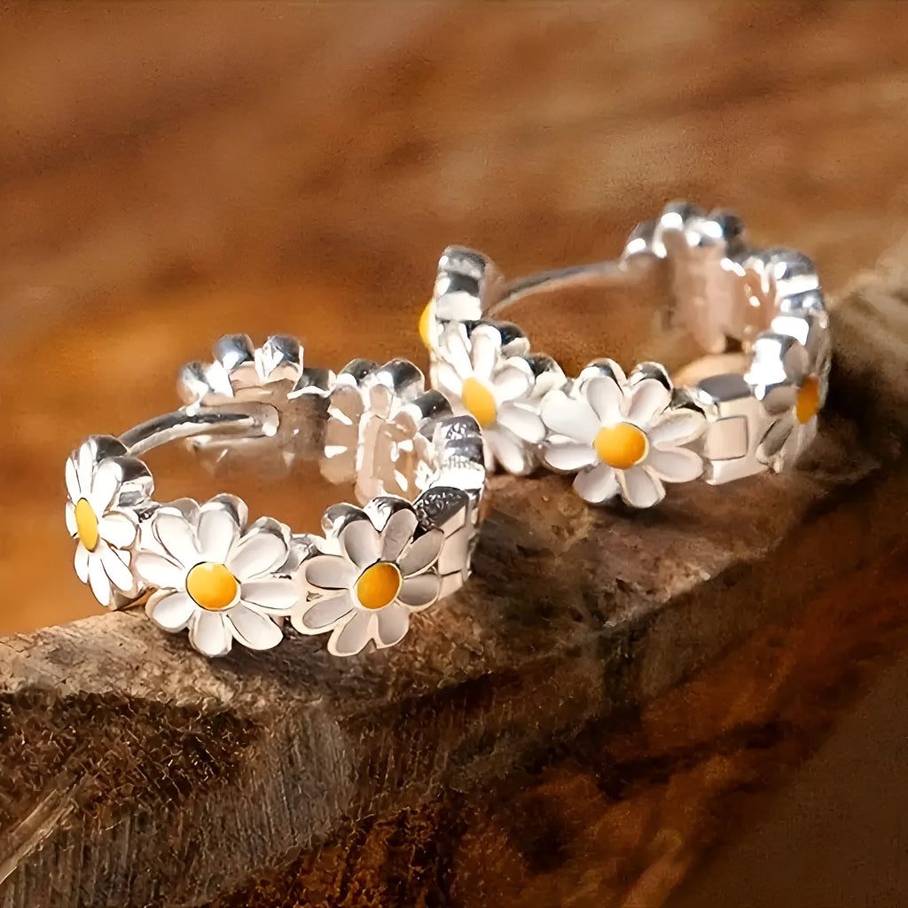 White daisy flower ring earrings with a platinum-colour gem setting.