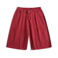 Casual apricot wide-leg cropped shorts with rivet details on a mid elastic waist