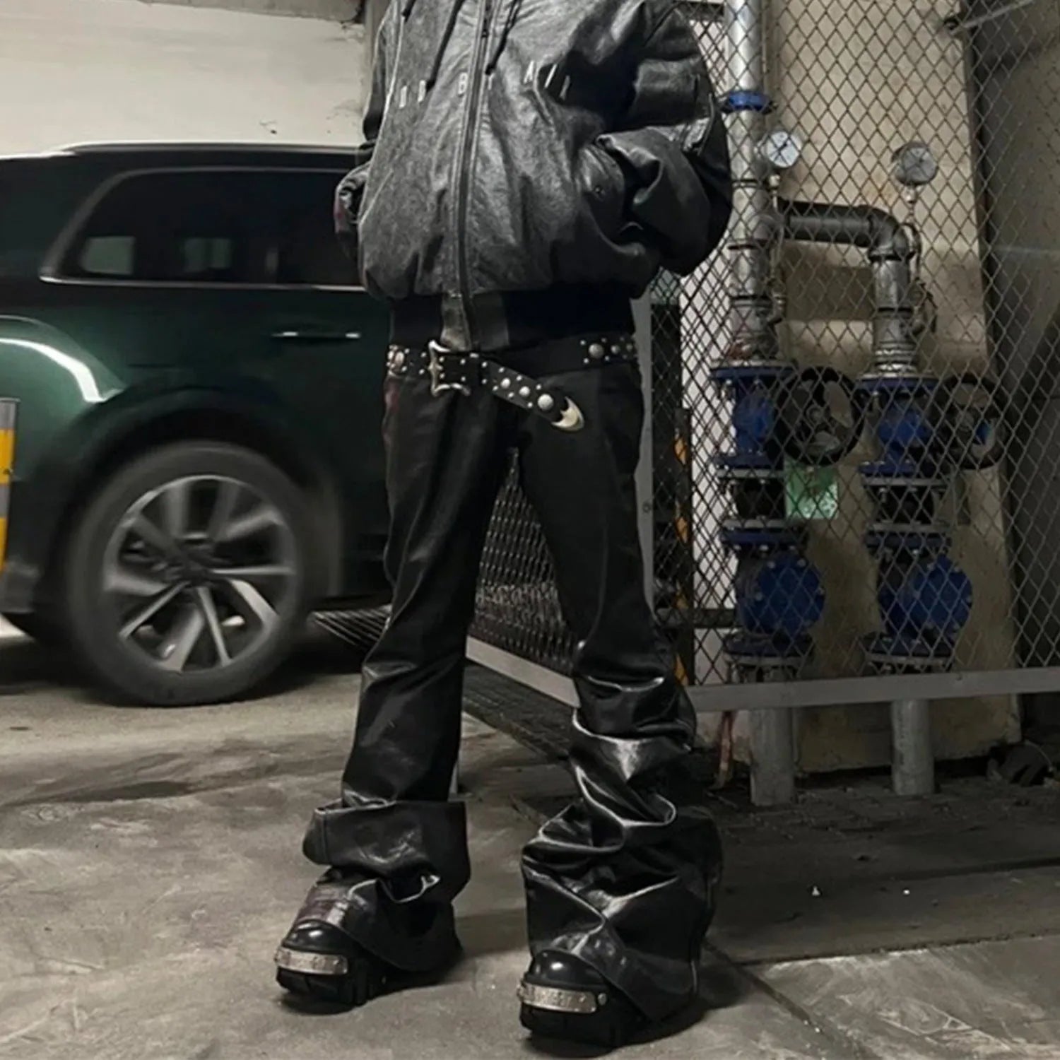 Black patent leather coated skinny jeans with straight leg silhouette and mid waist design