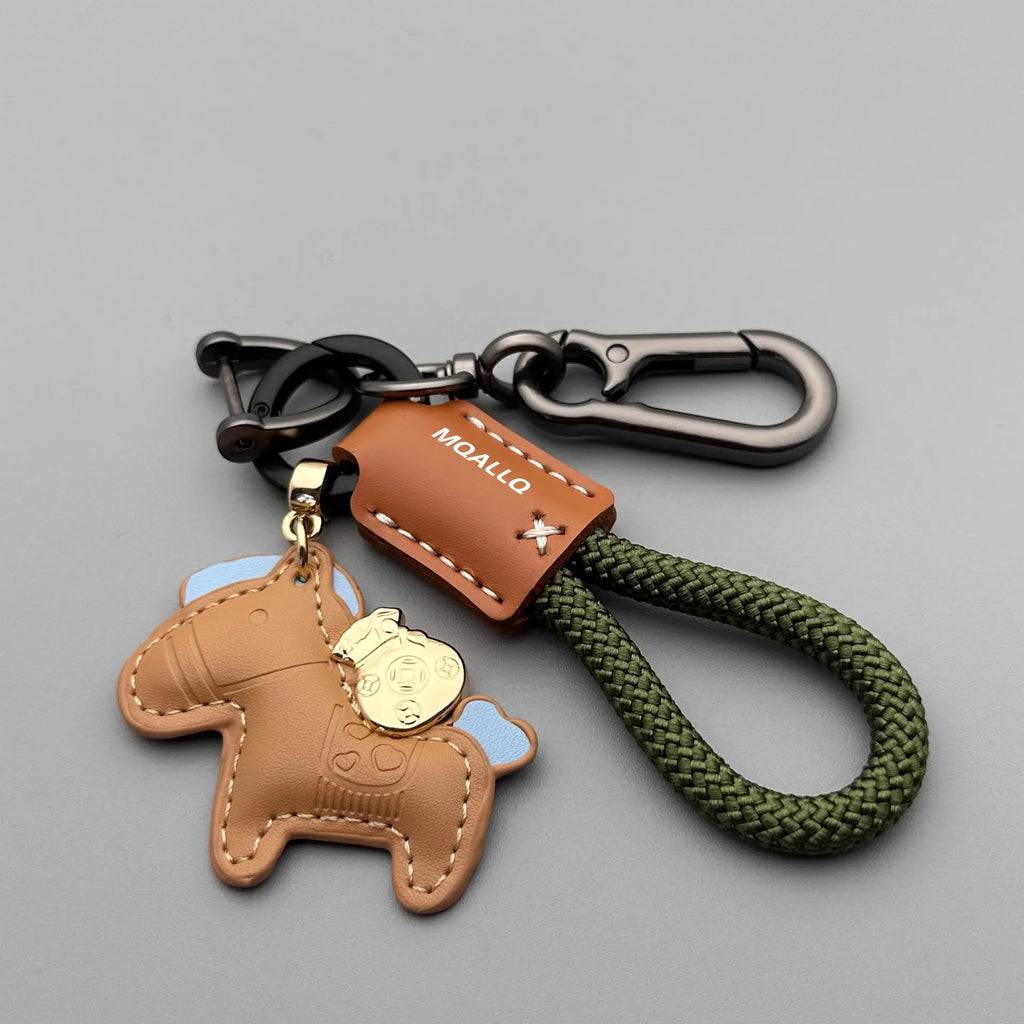 Handmade cowhide car keychain pendant with a zinc alloy pony buckle and coloured flanelle rope strap.