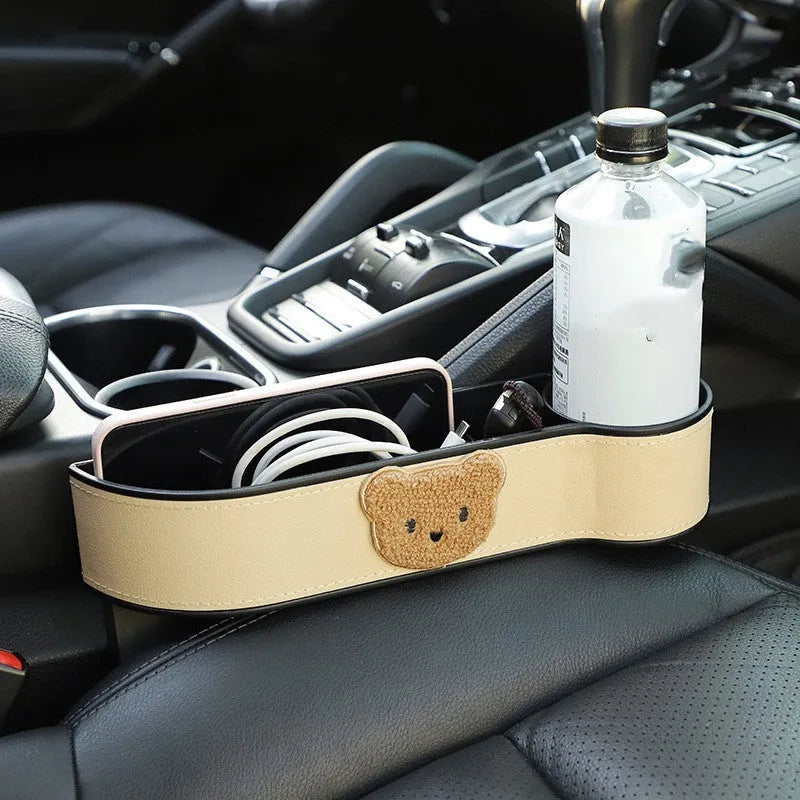 Leather car seat gap storage box with cartoon bear design for centre console organisation.