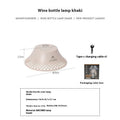 Beige wine bottle shaped camping lantern with USB-C port and control gear on top.
