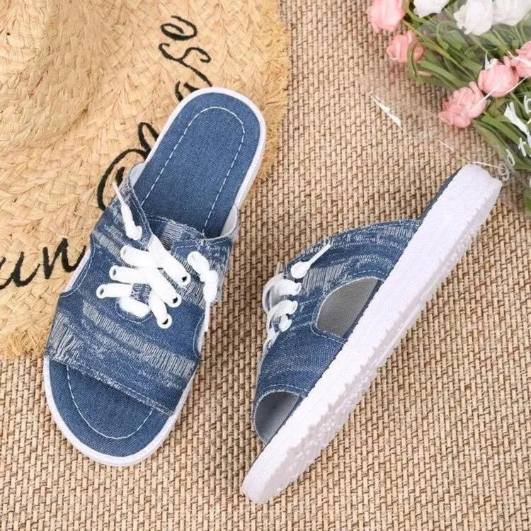 Blue Roman-style canvas slippers with flat rubber soles and cloth upper