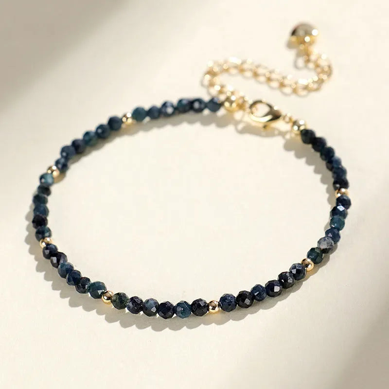 Blue tourmaline 3mm bead bracelet with spacer design on wrist