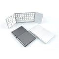 A closed black mini tri-fold Bluetooth keyboard showing its compact, slim 0.8cm profile.