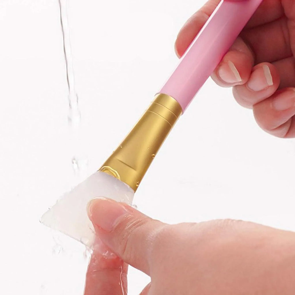 Reusable silicone face and body mask applicator spatula tool in one of six colours: black, blue, pink, rose red, white, or yellow.
