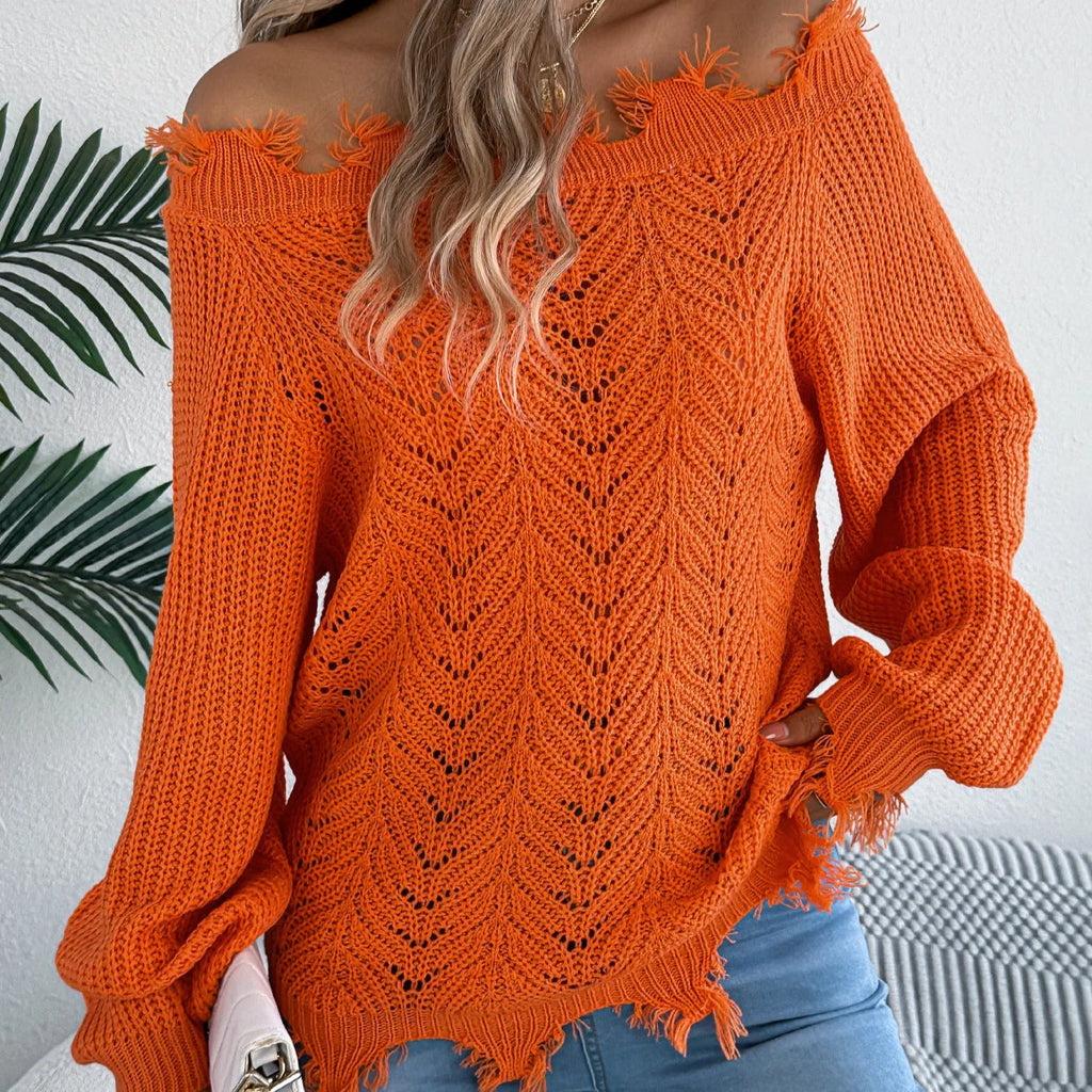White hollow-out long sleeve pullover sweater with an off-the-shoulder neckline on a hanger.