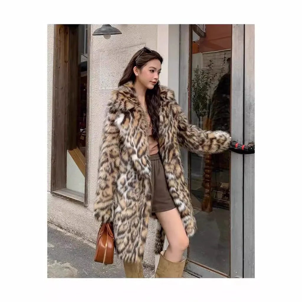 A model wearing a black faux fur mid-length coat with a large fur collar and front pockets.