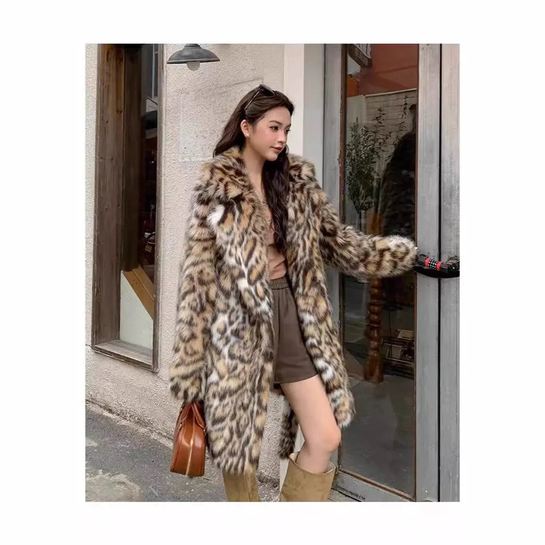 A model wearing a black faux fur mid-length coat with a large fur collar and front pockets.