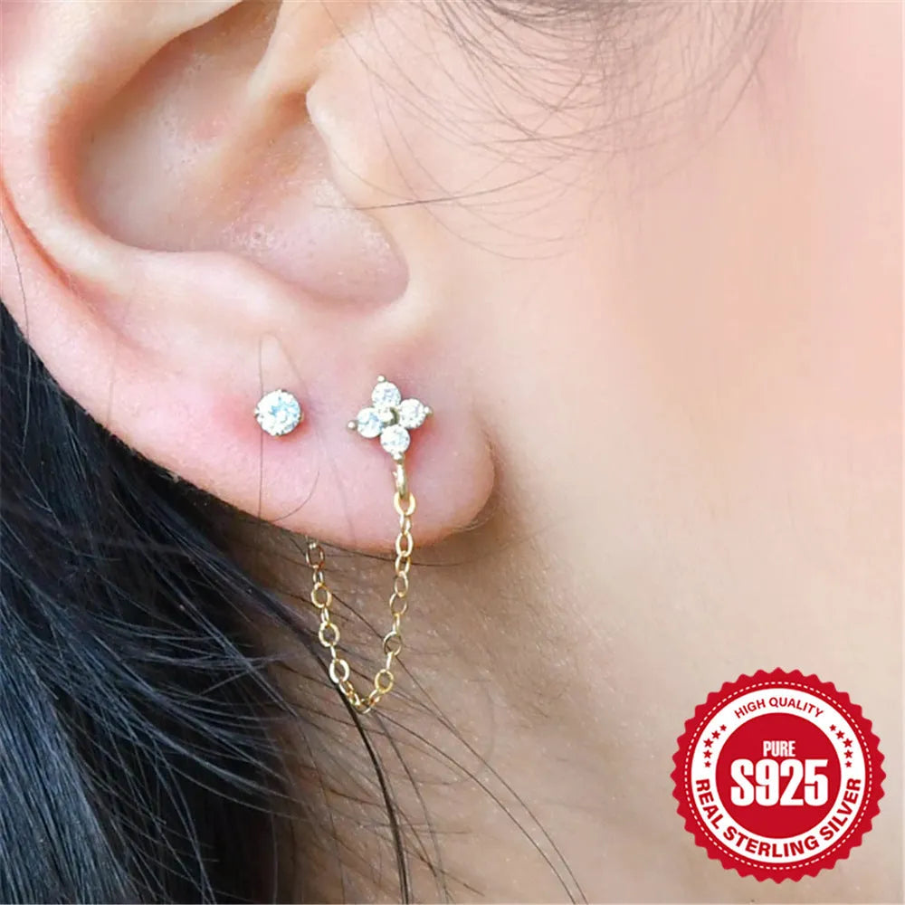 S925 sterling silver geometric ear clip stud earrings with chain, flower and tassel detail in gold electroplated finish.