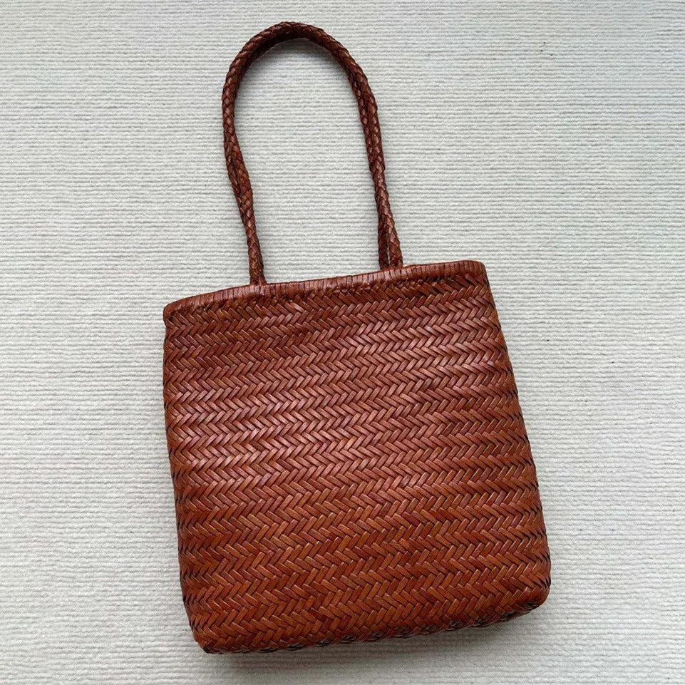 Brown handmade woven leather tote bag with three-dimensional pocket showing vintage texture