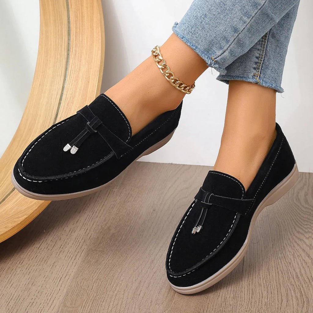 Canvas slip-on loafers in brown with round toe, rubber sole, and platform heel.
