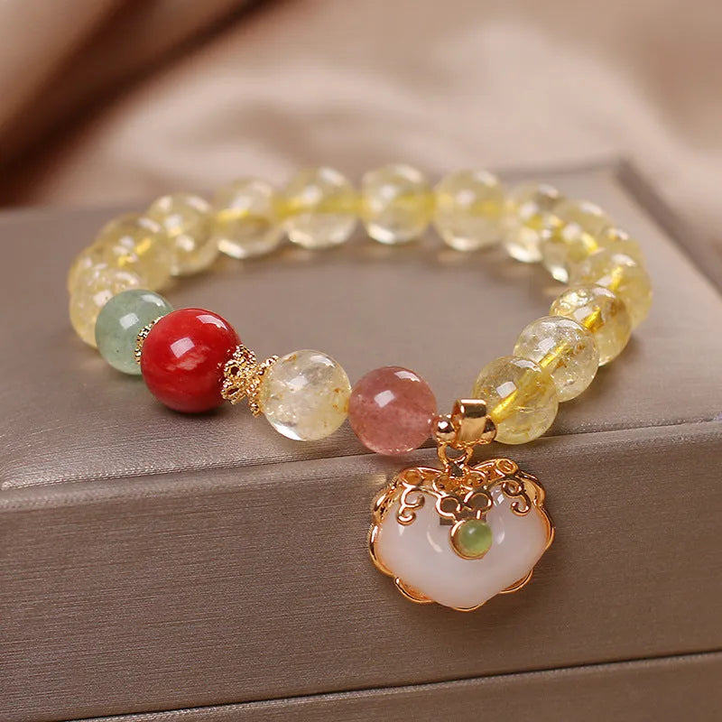 Women's bracelet with a yellow citrine jade ruyi pendant on an alloy chain.