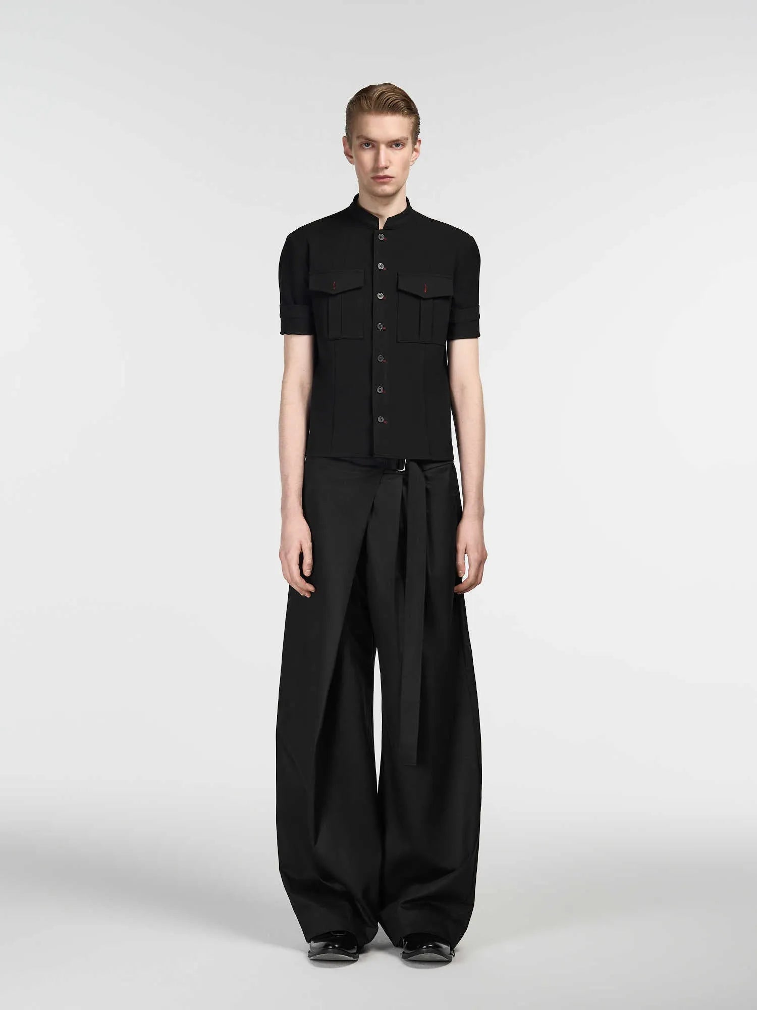Black straight-leg women's trousers with a pleated front and adjustable waistband on a neutral background.