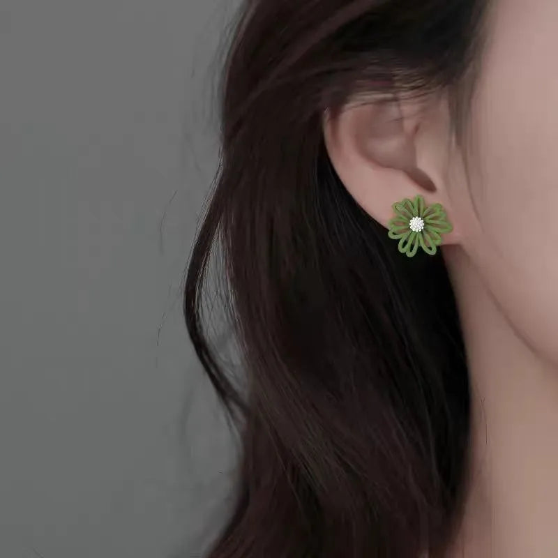 Cartoon flower stud earrings in blue and orange, white and green, or yellow and white alloy construction