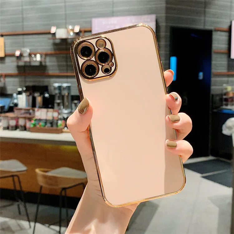 Gold plated cartoon design TPU protective case for iPhone on a table.
