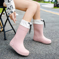 Women's solid colour PVC rain boot in apricot, shown on a white background.