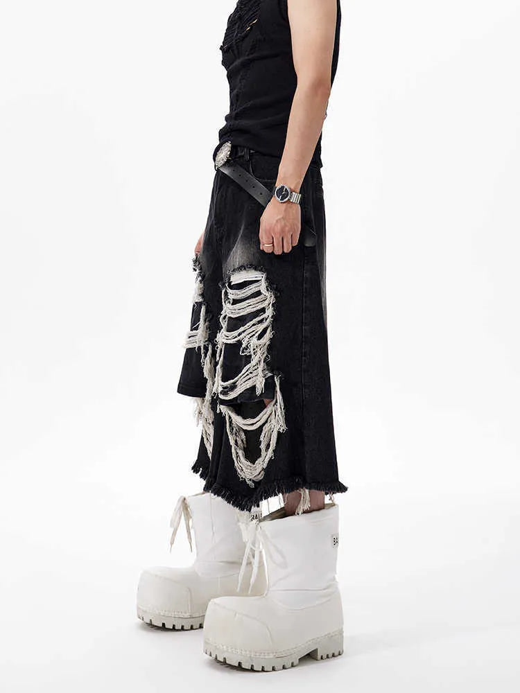 Black loose fit wide leg cropped jeans with a mid-high waist on a model.