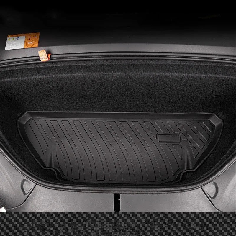 Black rubber floor mat for Tesla car interior with textured TPE footrest section.