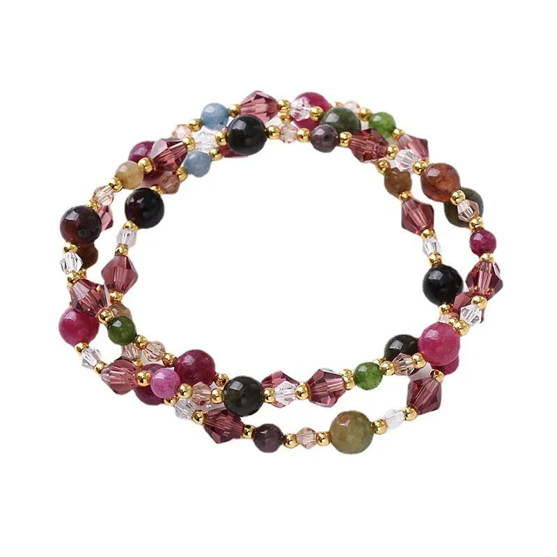 Women's adjustable bracelet with three rings of tourmaline, strawberry quartz, and amethyst crystal beads.
