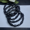 Natural black tourmaline rough stone bracelet with approximately 9mm beads on wrist