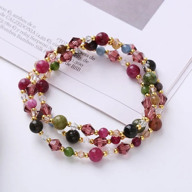 Women's adjustable bracelet with three rings of tourmaline, strawberry quartz, and amethyst crystal beads.