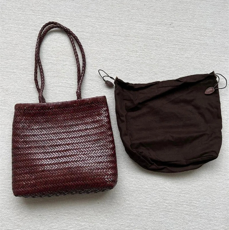 Brown handmade woven leather tote bag with three-dimensional pocket showing vintage texture