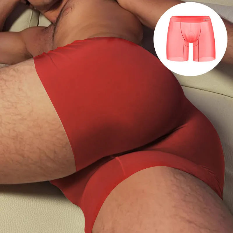 Orange seamless low-waist sports boxers for men on a grey background.