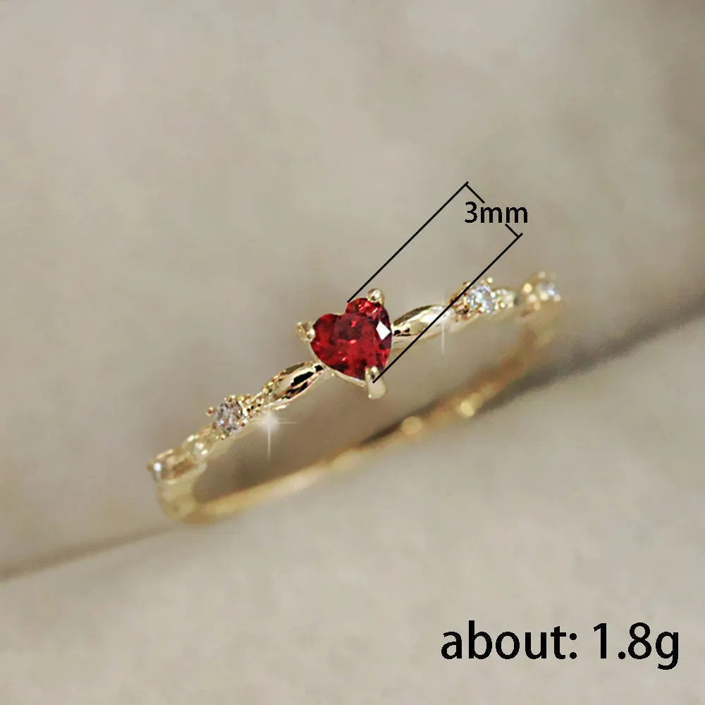 Gold or silver personalised zircon peach heart ring showing five available sizes on a ring sizer.