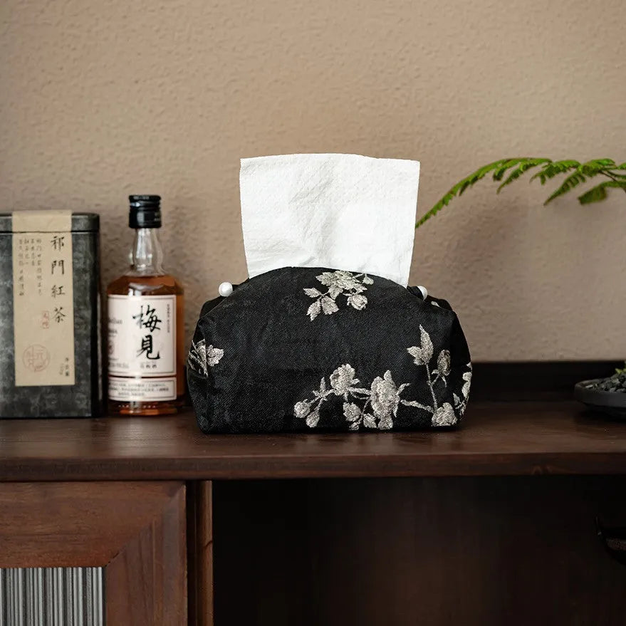Chinese brocade fabric tissue box with embroidered white plum design, shown with and without a pearl buckle.