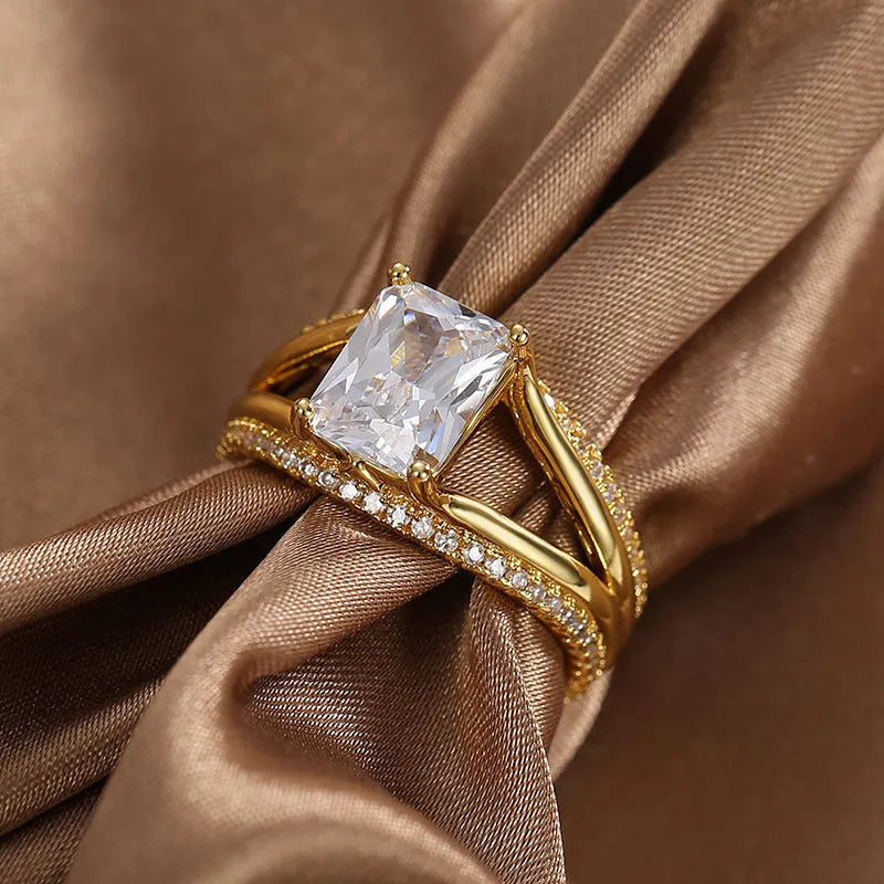 Geometric gold-coloured women's ring with a square zircon stone, shown in size options 6 to 9.