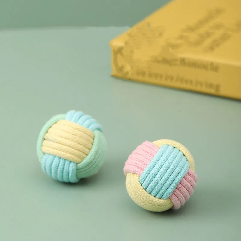 Small handmade cotton plush ball cat toy in blue powder, green blue, or pink green colours, 5cm diameter.