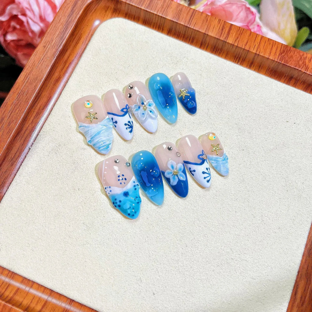 Blue carved transparent fake nails with hand-painted patterns in four sizes