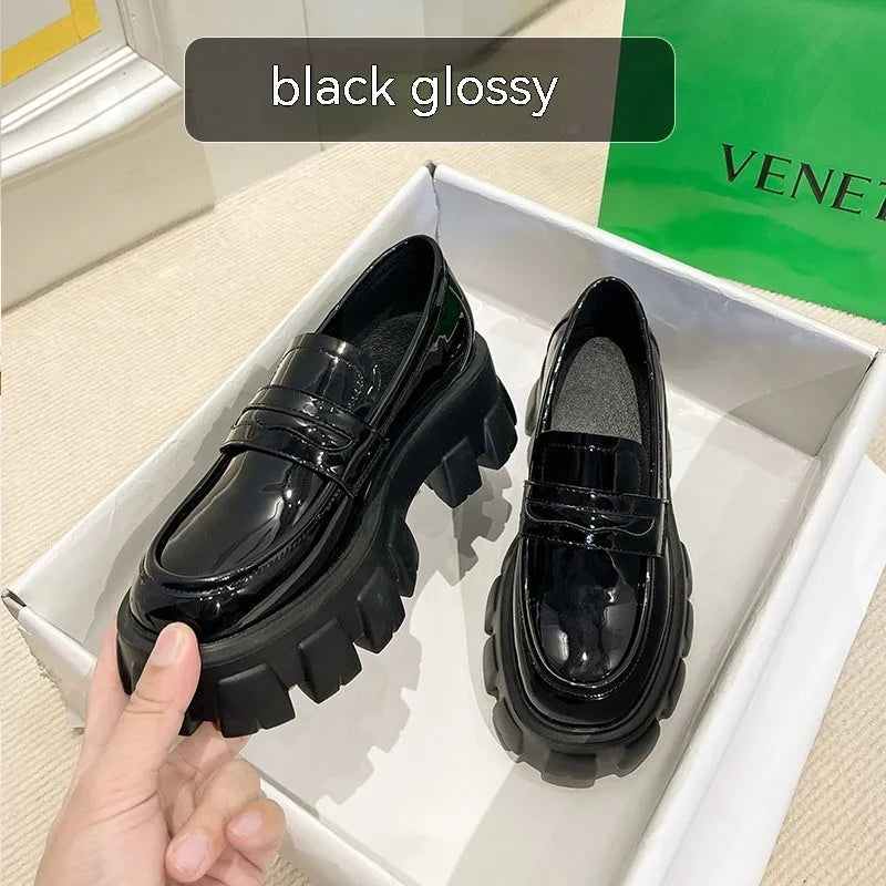 Men's wide fit British style loafers in patent leather with a rubber sole and muffin heel.