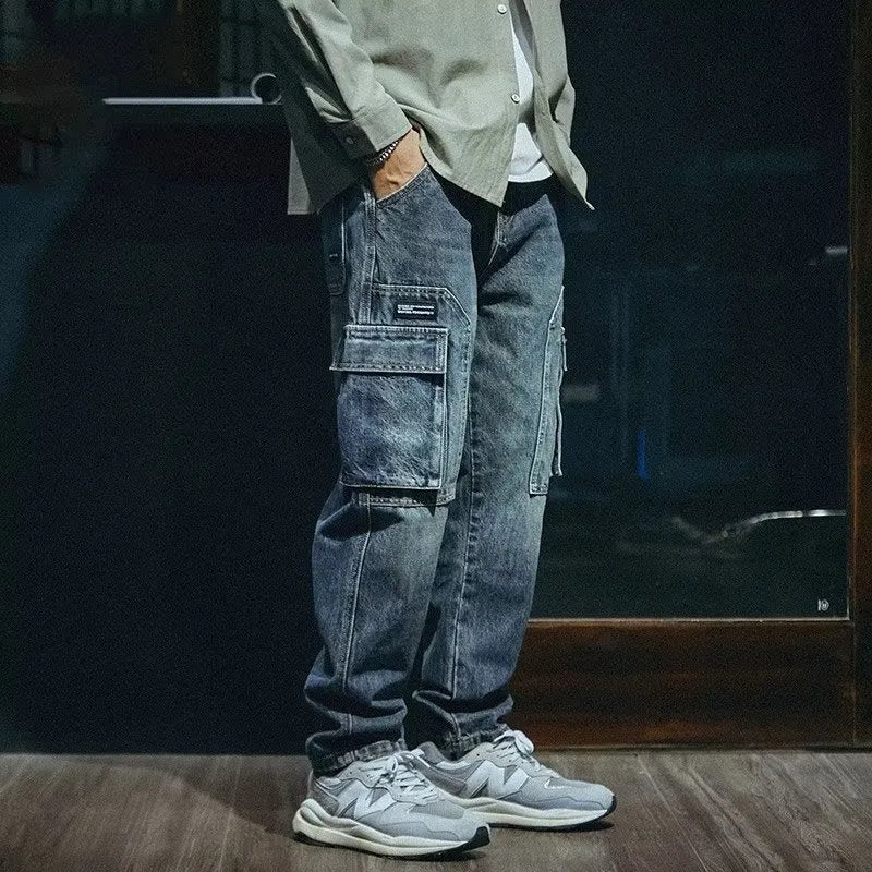 Blue men's loose straight-leg jeans with a zip fly on a neutral background.