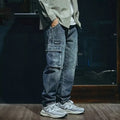 Blue men's loose straight-leg jeans with a zip fly on a neutral background.