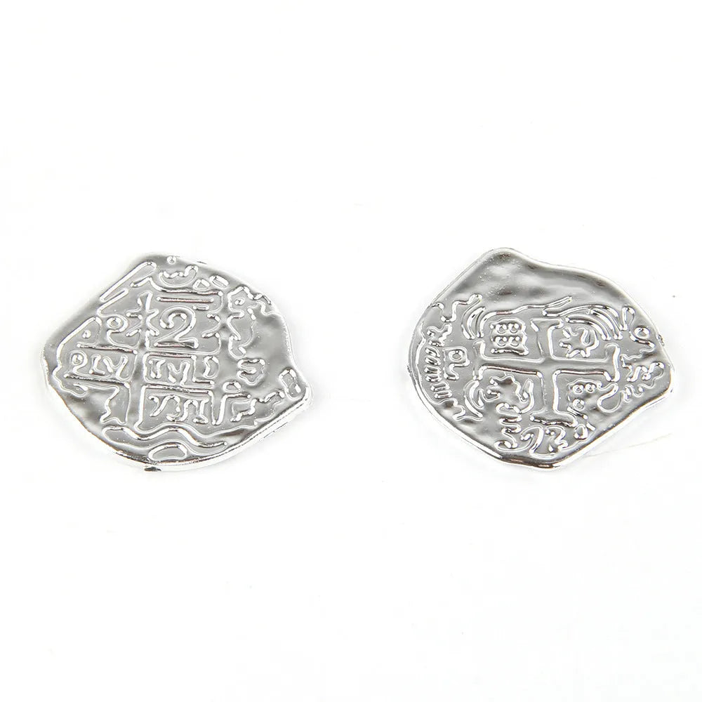 100 plastic Roman coin replicas with metallic bronze, gold, and silver electroplated finishes displayed together.