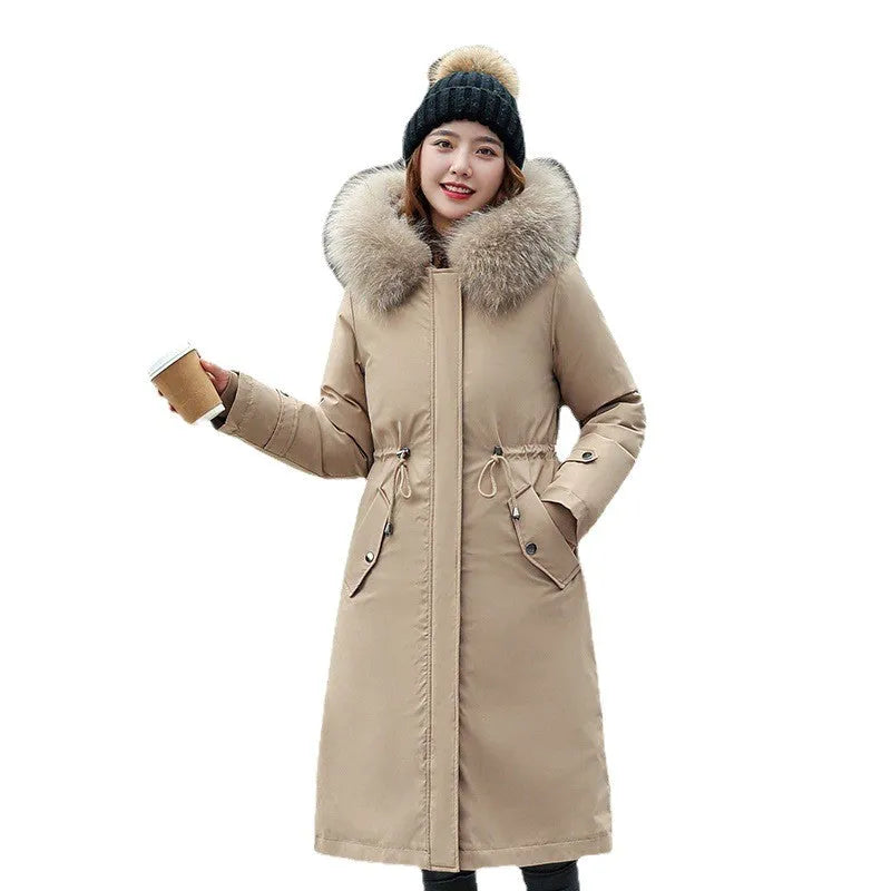 Women's long beige trench coat with a two-way zip and extended length, shown in an elegant style.