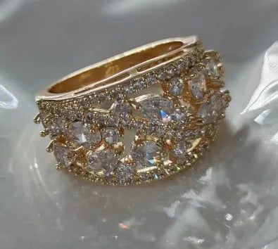 Women's hollow round copper fashion ring shown in gold and platinum colour finishes with a sizing chart.