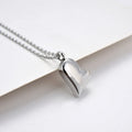 Curved peach heart silver stainless steel pendant necklace on display showing chain and pendant detail