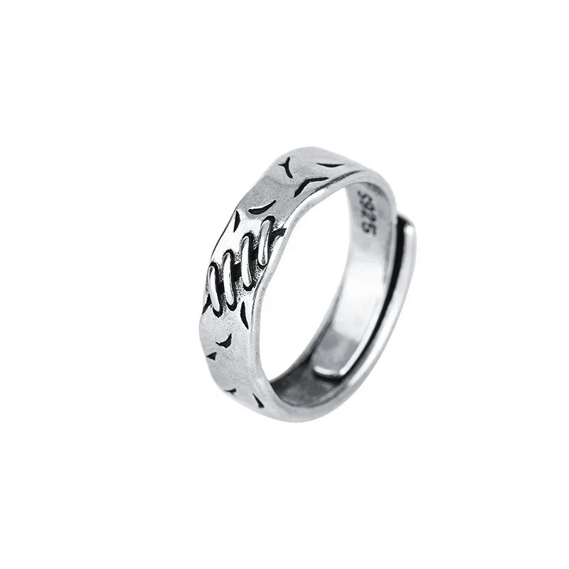Black geometric copper women's ring with adjustable opening showing round and oval design elements