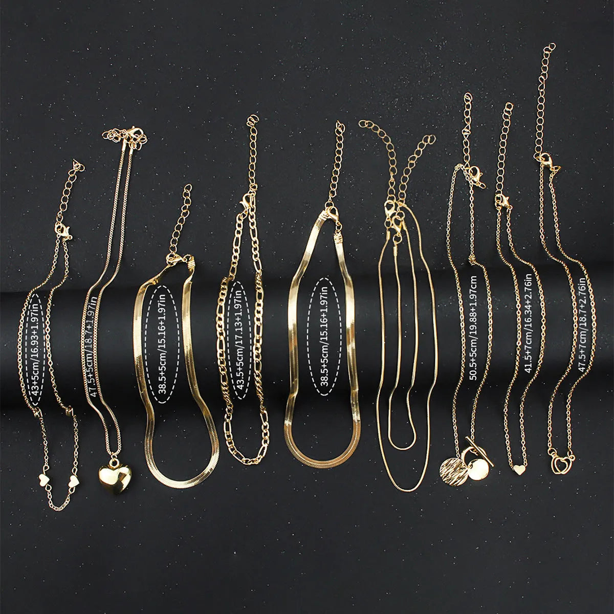 Set of 10 gold electroplated necklaces with alloy pendants on snake bone chains