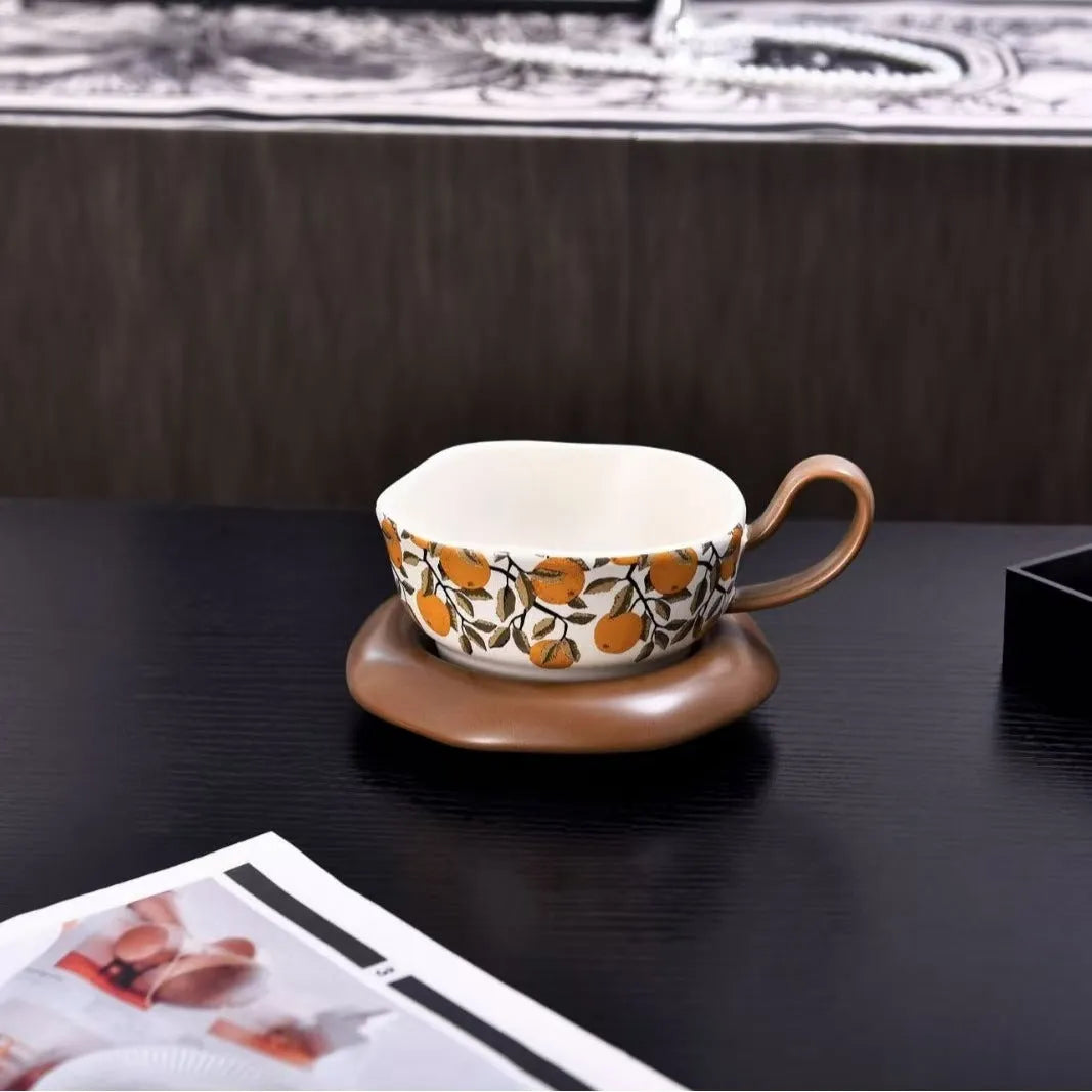 Antique style ceramic coffee cup and saucer set in black pomegranate or orange citrus retro design.