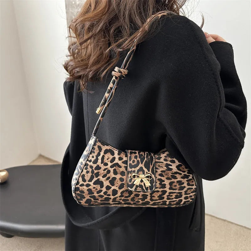 Women's casual PU handbag with sandwich pockets in black colour showing 27cm width