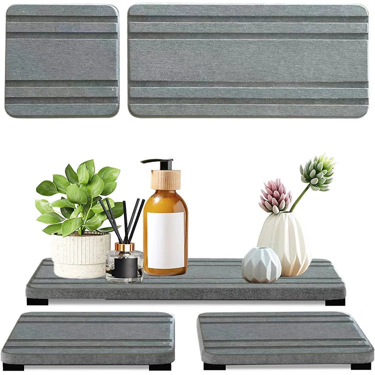 Set of three solid colour diatomite square drying mats for bathroom countertops.