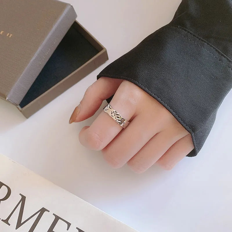 Black geometric copper women's ring with adjustable opening showing round and oval design elements
