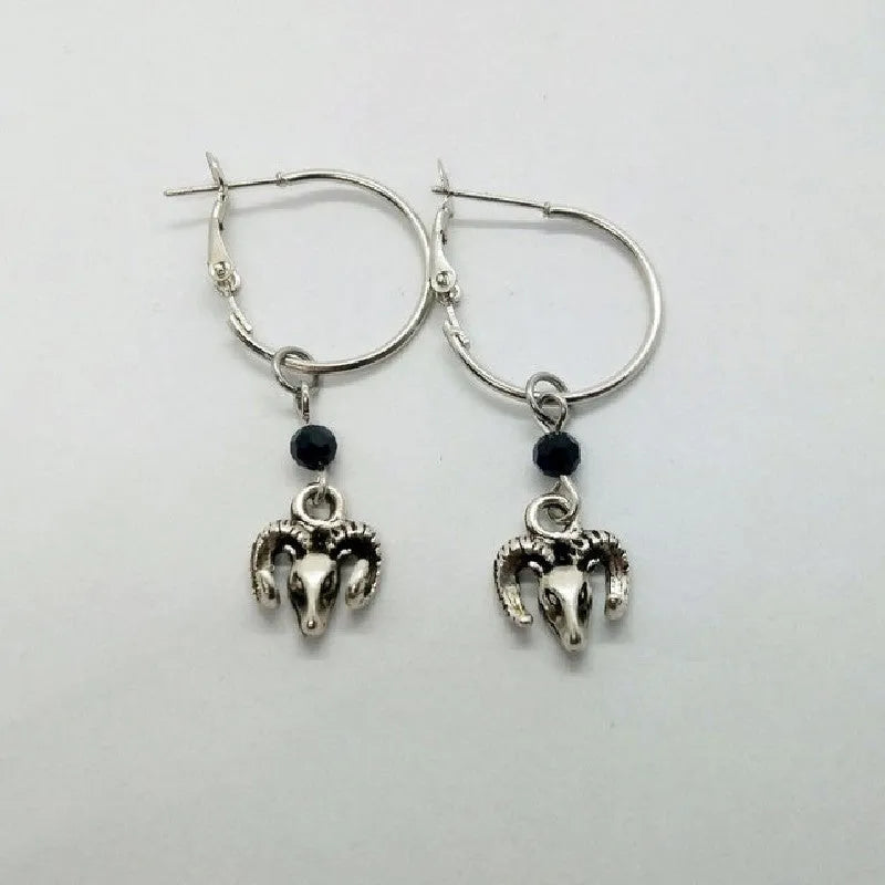 Silver alloy women's earrings with round ring design and Tibetan antelope motif.