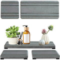 Set of three solid colour diatomite square drying mats for bathroom countertops.