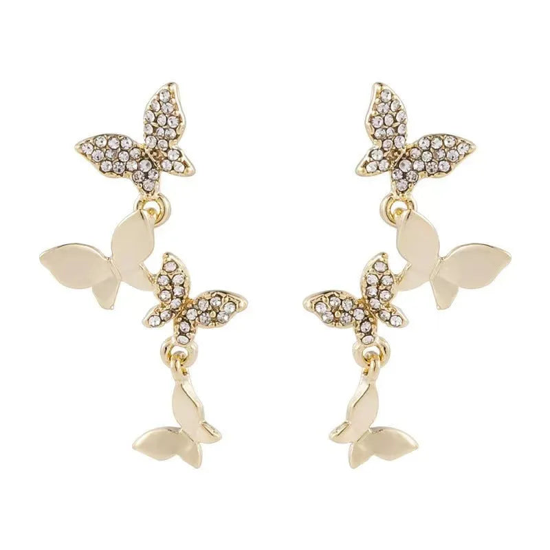 Women's butterfly copper earrings with gold-coloured drops and natural style design