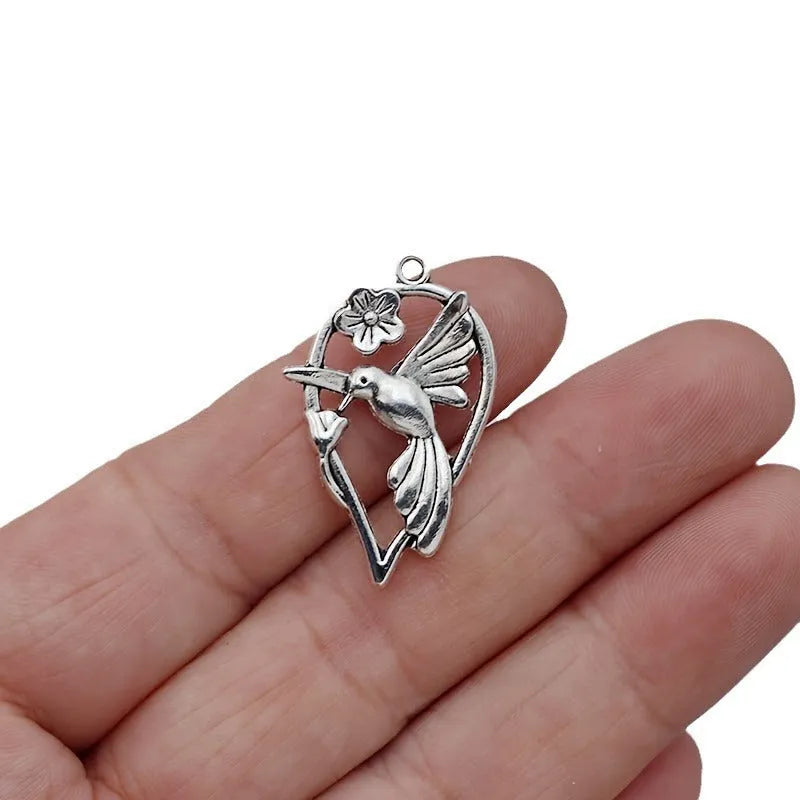 Gold-coloured alloy magpie bird charm pendant for DIY necklace or bracelet making.